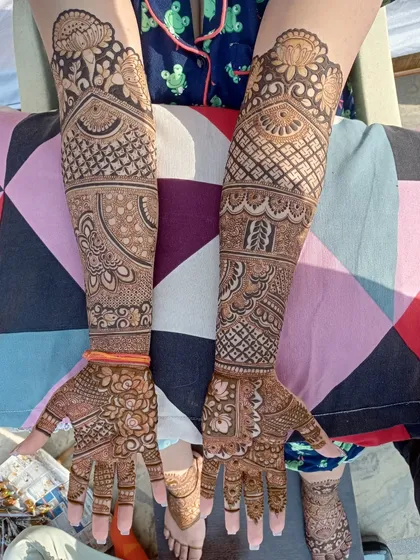 A complete elbow-length bridal design with a variety of textures and motifs. You can see the intricate jaal work, floral bands, and a beautiful dome pattern at the top.