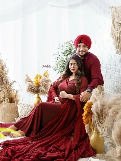 This expecting mother looks absolutely radiant in a flowing red gown. My studio is equipped with a variety of props and seating to create stunning, comfortable poses.