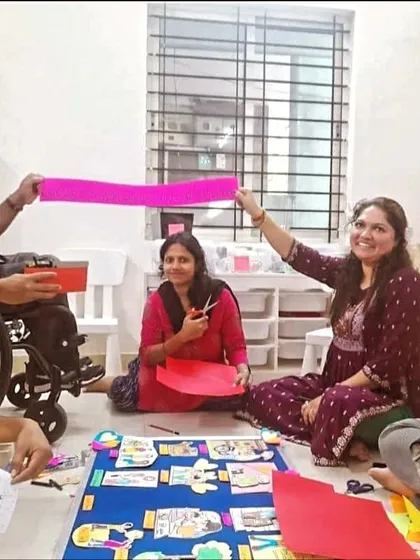 All smiles during a crafting session. This photo perfectly captures the inclusive spirit of our events, with volunteers of all abilities working side by side.