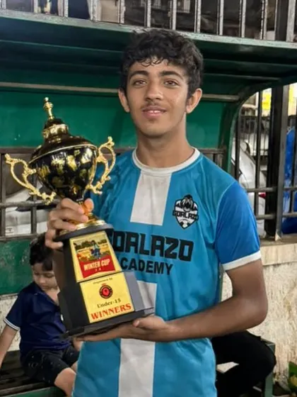 A moment of pride for our Under-15 player, holding the winner's trophy from the Winter Cup in Kurla.