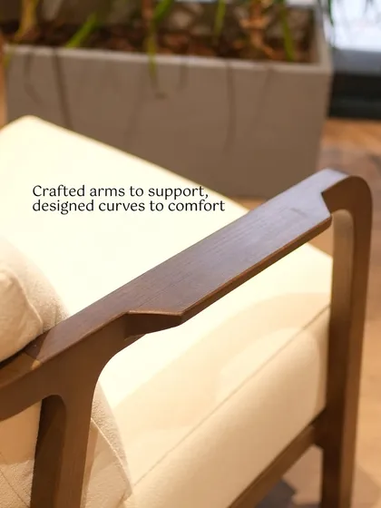 The difference is in the details. This close-up reveals the smooth, ergonomic curve of an armchair's armrest, a small but significant detail designed for comfort and handcrafted to support you for years to come.