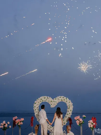 A magical proposal moment set against the Mumbai shoreline. We coordinated this shot with fireworks to create a truly spectacular and unforgettable memory, framed by a heart of white roses.