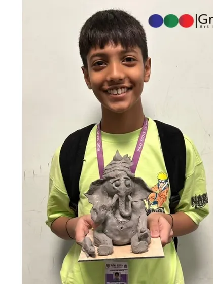 Every idol has its own personality. This student shows off his unique creation after our hands on Shadu Mati clay workshop.