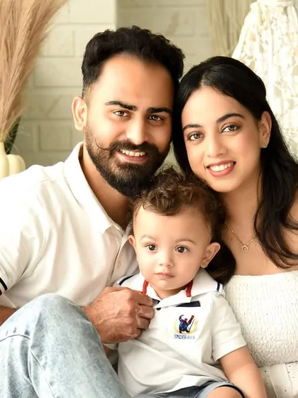 A beautiful, close-up family portrait. The direct eye contact from the parents and child creates an intimate and engaging photo that draws the viewer in.