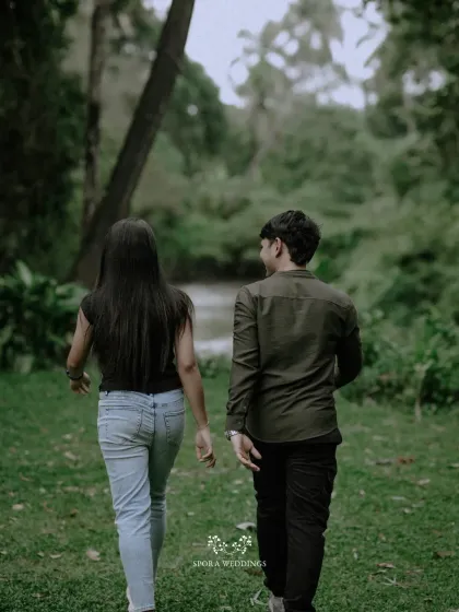 The couple walking away together into a lush, green landscape, symbolizing the beginning of their path together.