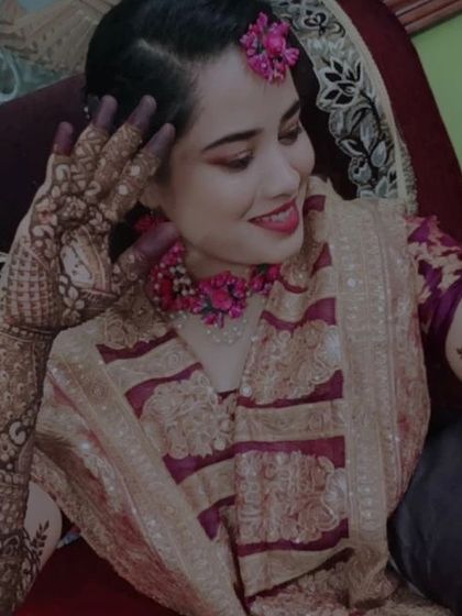 A beautiful candid shot of the bride. Her smile and the intricate henna on her arms capture the happy spirit of the occasion.