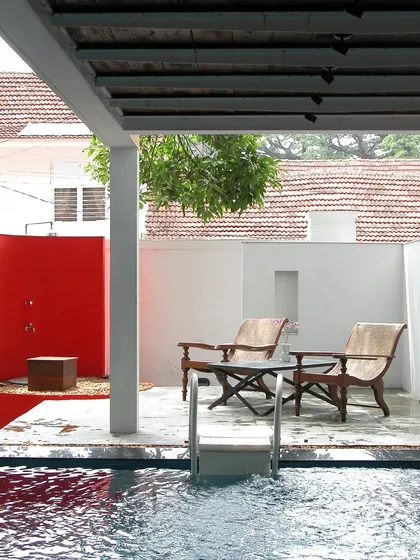 In restoring the 1740 Stuber Hall in Fort Kochi, we carefully introduced modern comforts without disrupting the building's soul. This private pool and courtyard, with its bold red accent wall, creates a contemporary sanctuary within the historic Dutch structure, a dialogue between past and present.