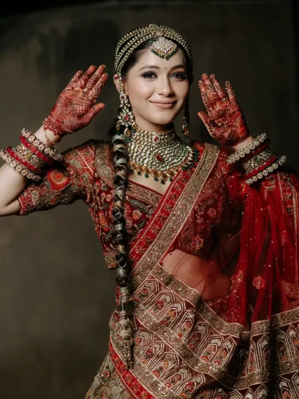 A playful moment showing off her beautiful henna. The makeup is kept elegant and classic to balance the intricate details of her look.