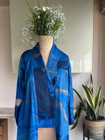 A studio shot of the Azure Overlay, a layered piece inspired by the stillness of sea and sky. The tones of blue whisper depth and ease.