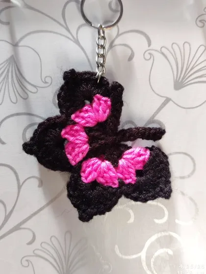 Elegant black butterfly keychains with pops of color like orange, blue, pink, purple, and yellow on the wings.