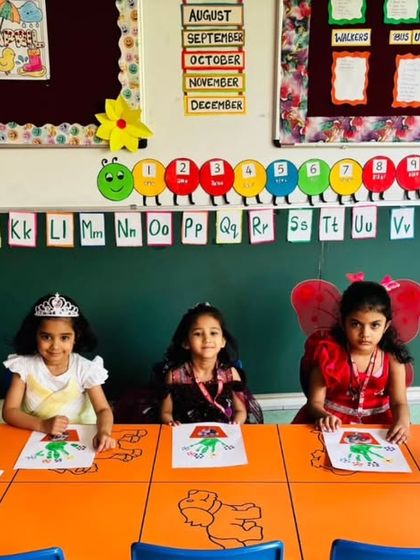 Our youngest learners, dressed as fairies and princesses, sit at their desks ready for a hand-painting craft session. We make learning and creating a magical experience for our pre-primary students.