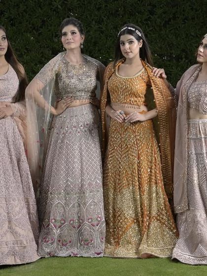 A beautiful lineup of our pastel and golden lehengas, showcasing a range of unique designs and color combinations perfect for a modern bridal party.