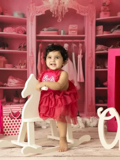 A little girl celebrating her first birthday, Barbie style. I provide the costume and props to make her milestone shoot extra special and vibrant.