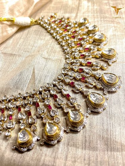 This Polki and Ruby masterpiece is designed for unapologetic grandeur. The cascading uncut diamonds and vibrant rubies create a look of pure heritage and elegance, defining your presence in any room.