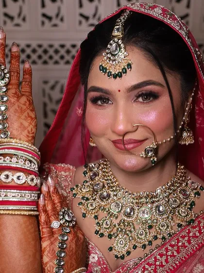 A classic bridal pose. This shot highlights the hand jewelry and the flawless makeup, from the defined eyes to the soft, radiant blush.
