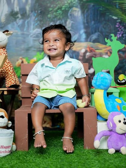 A beautiful, genuine smile from the little one during his jungle adventure photoshoot. His bare feet and happy expression show how comfortable and relaxed he is.