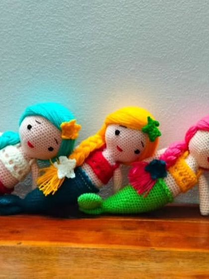 Three beautiful mermaids relaxing together. Each one is handmade with high quality, colorful yarn.