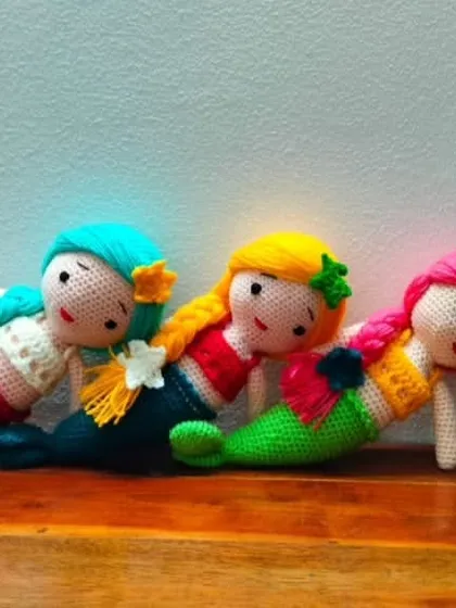 Three beautiful mermaids relaxing together. Each one is handmade with high quality, colorful yarn.