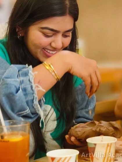 A close-up of a participant fully engaged in her creation during a pottery date workshop. These events are designed to be fun, interactive, and perfect for beginners.