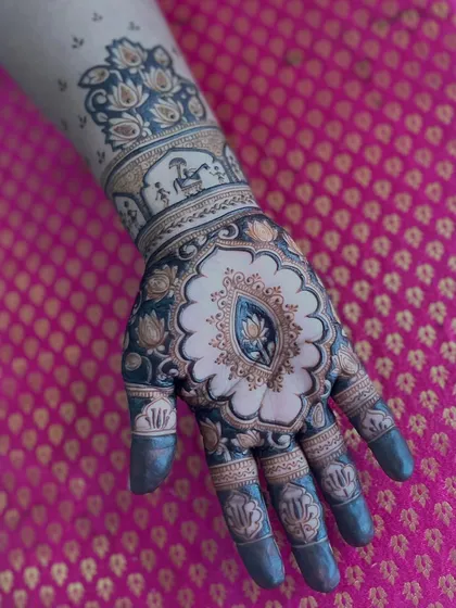 A stunning design with a central lotus motif in a scalloped frame. The arm features a doli scene, adding a touch of bridal story.