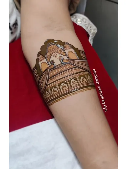 More details are added, including the delicate patterns within the palace architecture and the peacock's feathers.