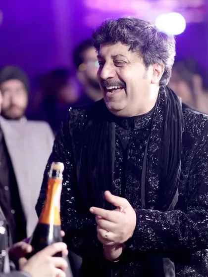 A candid shot of guests laughing and enjoying the celebration.