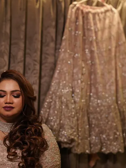 A behind-the-scenes shot with her lehenga hanging in the background.