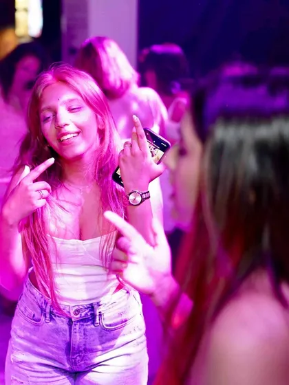 A guest having fun and interacting with her friends on the dance floor.
