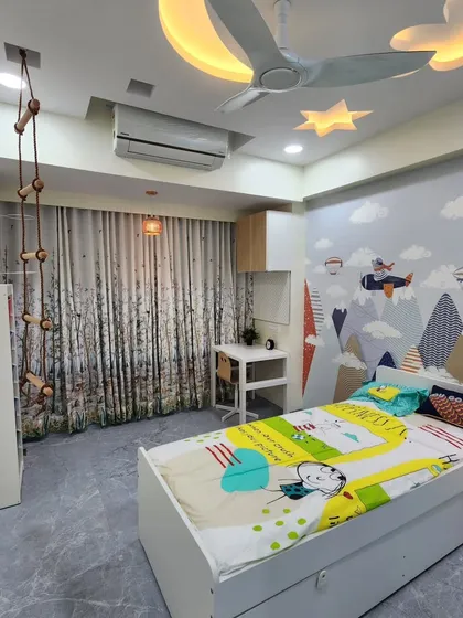 This view shows the complete layout of the room, including the bed with a trundle for extra sleeping space.