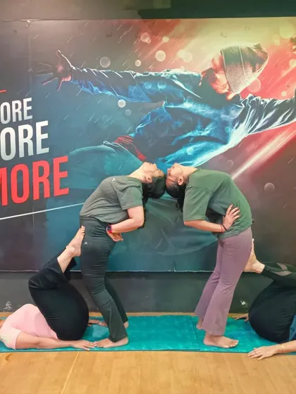 This partner pose requires core strength and balance from all four participants. It's a playful way to build stability and teamwork in our Acro Yoga sessions.