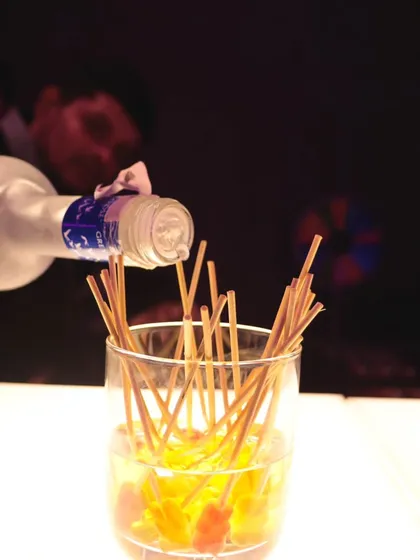 A creative way to serve a group shot. This multi-straw drink is perfect for friends who want to share a fun moment at the bar.