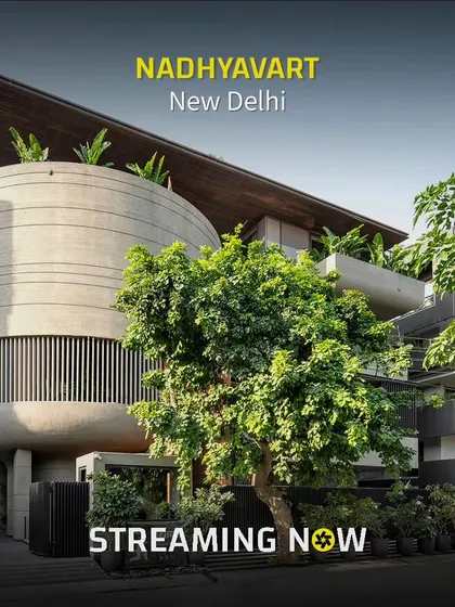 Surrounded by greenery, the 'Nadhyavart' project showcases a fusion of concrete and wood. The design was conceived as two separate yet connected blocks for two brothers, unified by a shared architectural language.