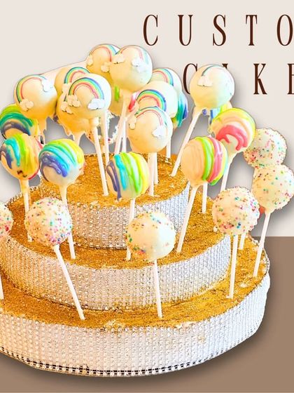 A creative display of rainbow and sprinkle cake pops arranged on a tiered stand, perfect for parties.
