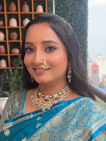 A smiling portrait that showcases her natural beauty, enhanced by a soft and radiant makeup application. The look is perfect for a daytime engagement party.
