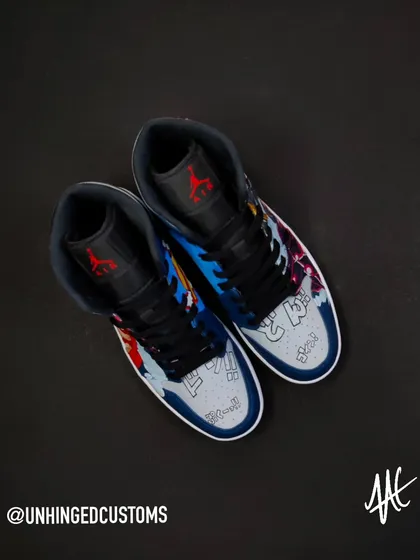 A top-down view of the custom Luffy Gear 4 Jordan Mids. The design covers the entire shoe, including the toe box which features Japanese sound effects from the manga.