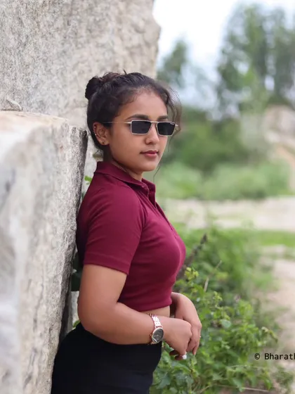 A profile shot of the model with her sunglasses on, looking away from the camera.