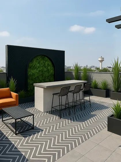 An entertainer's dream on a Gurugram rooftop. This design features a sleek outdoor bar, a comfortable L-shaped sofa, and modern planters, all set against a backdrop of the city skyline. The chevron floor pattern adds a contemporary touch.