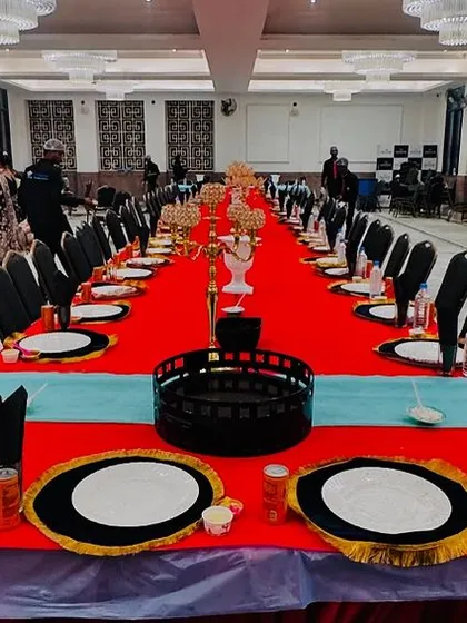 The main table is set and ready for the feast. The vibrant red and blue decor, combined with our elegant plating, sets the stage for a royal meal.