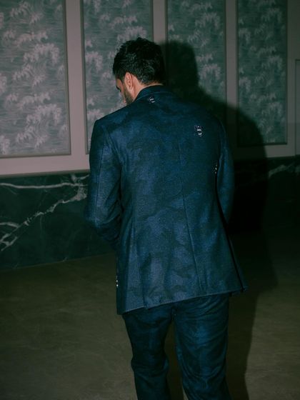 Shakti Yadav in our dark blue suit, expertly designed with military camouflage detailing and the intricate SGM logo motif. This is where tradition and modernity blend seamlessly.