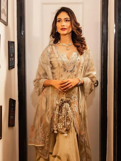 A beautiful portrait of actress Aneri Vajani. The soft glam makeup with a bold red lip enhances her features, and the voluminous curls frame her face perfectly.