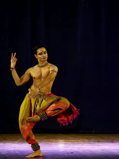 A full-stage view of a solo piece in Pune. The colorful costume and focused lighting help create the right atmosphere for the story being told.