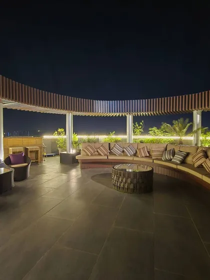 We transformed this rooftop into a luxurious terrace lounge, perfect for entertaining with a view. The space features a custom curved wooden pergola, comfortable sectional seating, and ambient lighting to create a relaxed, resort-like atmosphere at night.