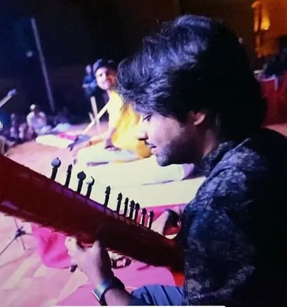 Lost in the music during a Zitar performance in Ahmedabad. The Zitar's distinct red body and powerful sound make it a visual and auditory centerpiece on stage.