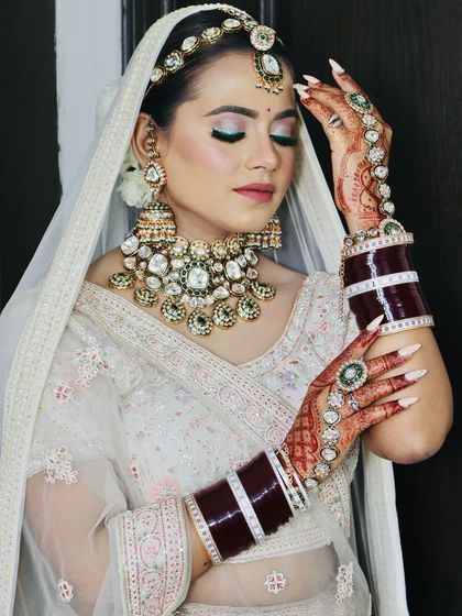 The bride showing off her beautiful hands and the intricate details of her look.