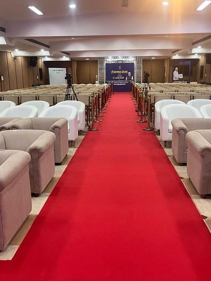The main auditorium setup for the Rozgar Mela, featuring a mix of sofa and banquet seating. We provide versatile seating solutions to accommodate VIPs and general attendees in a formal setting.