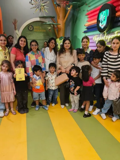 A happy mommy group poses with their little ones. Our indoor space is perfect for parents to socialize while their kids play safely.