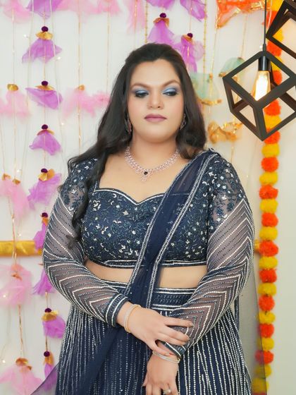 A dazzling look featuring blue glitter eyeshadow. This makeup is bold, glamorous, and sure to turn heads at any party.