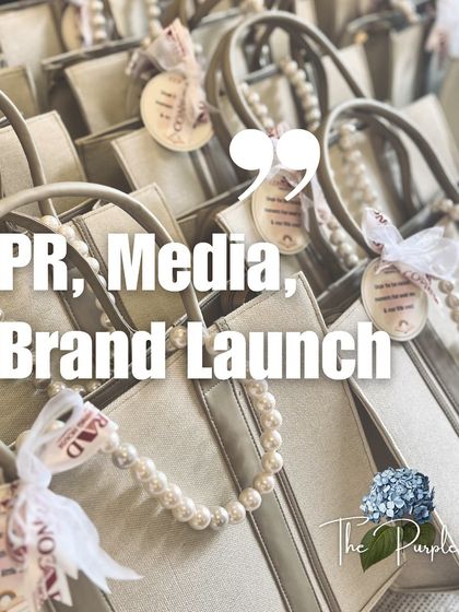 This image showcases a collection of elegant tote bags prepared for a PR or brand launch event. The pearl handle detail elevates a simple bag into a luxurious and reusable piece of merchandise.