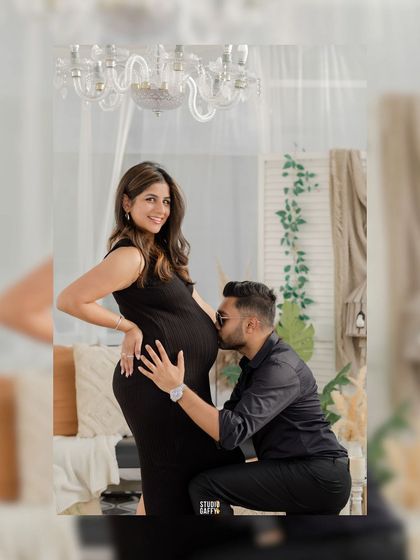 A tender kiss for the baby bump, a simple yet powerful expression of a father's love and excitement.