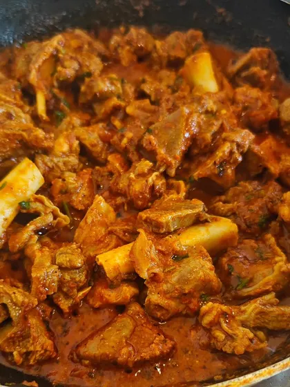 A close-up of my signature Kolhapuri Mutton. People think Kolhapuri food is just fiery red, but it's about a deep, enjoyable spice that comes from my Aai's special masala. This is the authentic taste I want you to experience.